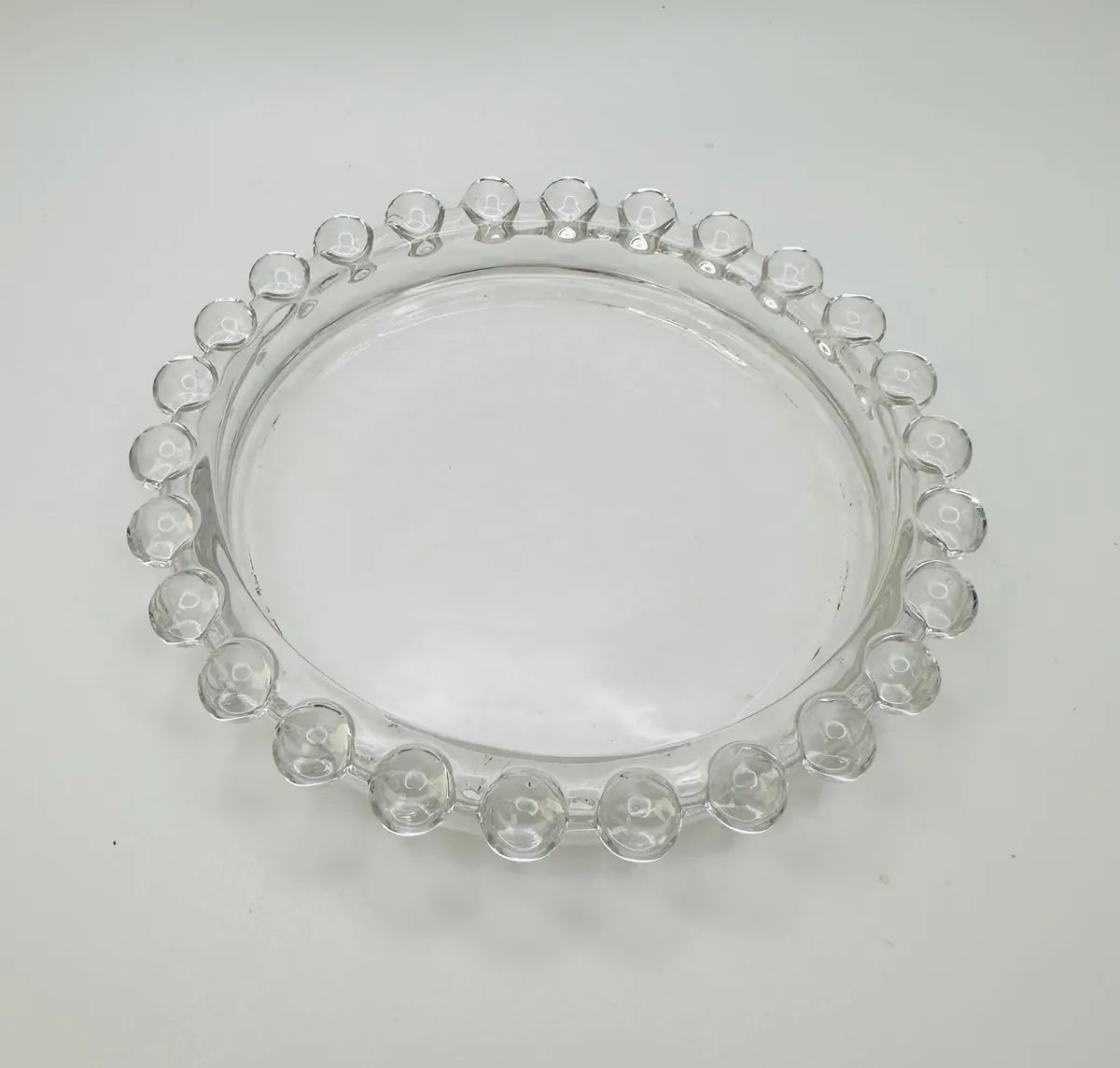 Clear glass candle holder decorated with glass beads